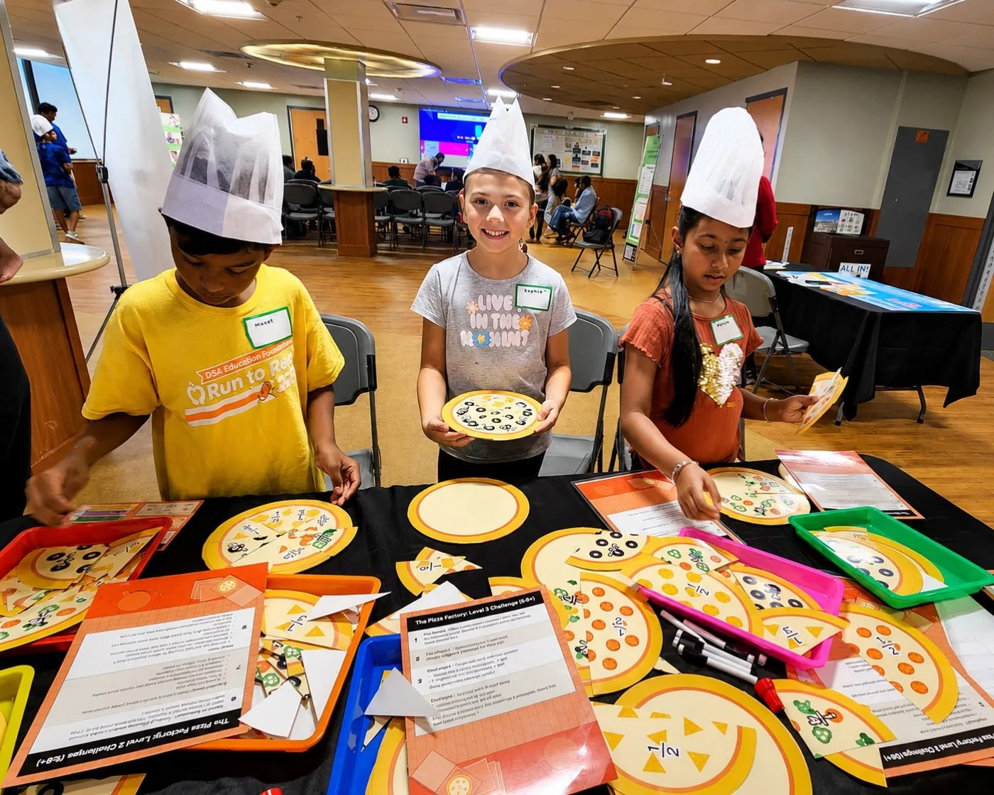 Kids at the fractions pizza station